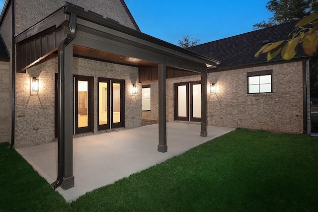 rear view of property featuring a patio area and a yard