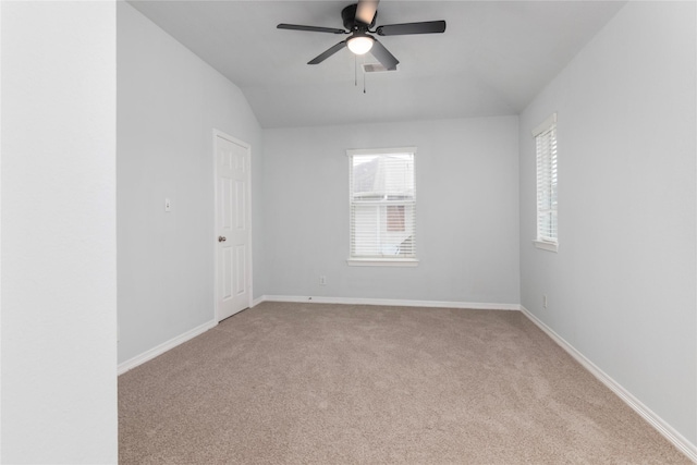 unfurnished room featuring ceiling fan, vaulted ceiling, and light carpet