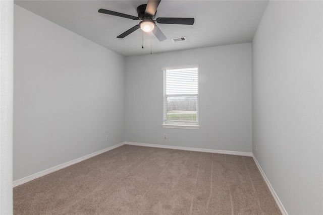 carpeted empty room featuring ceiling fan