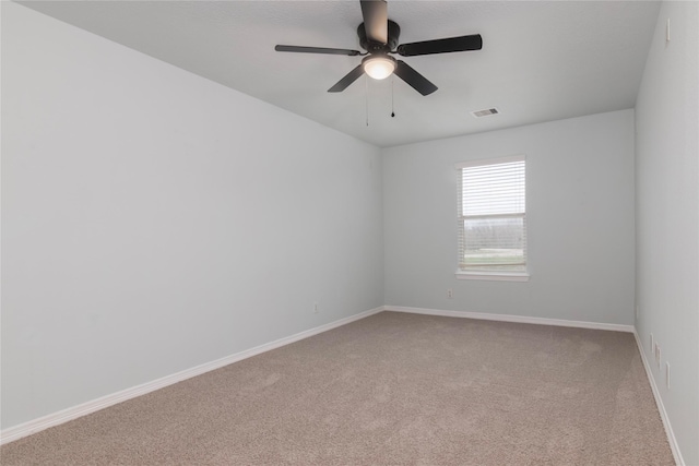 carpeted spare room featuring ceiling fan