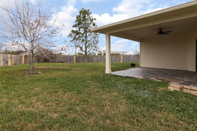 view of yard featuring ceiling fan and a patio