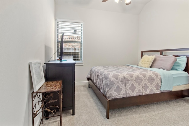 carpeted bedroom with vaulted ceiling and ceiling fan