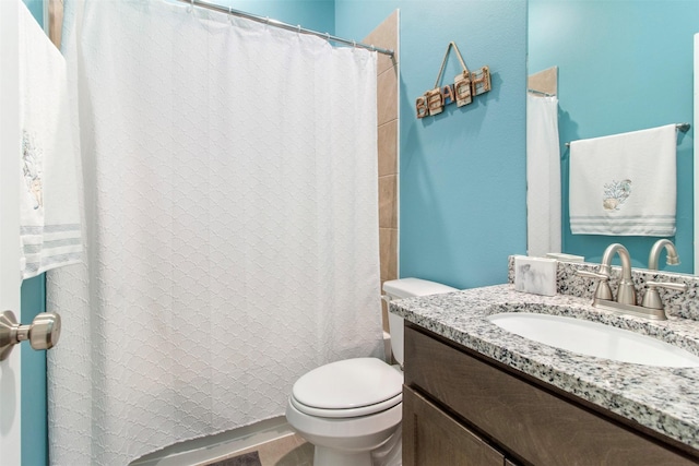 bathroom with toilet and vanity