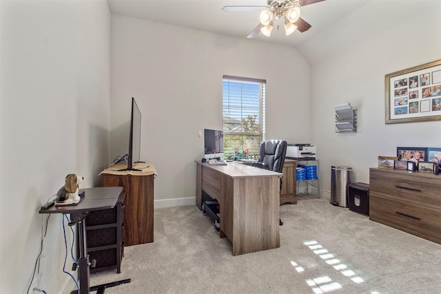 carpeted home office featuring lofted ceiling and ceiling fan