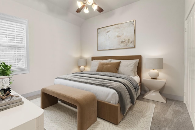 carpeted bedroom with ceiling fan and lofted ceiling