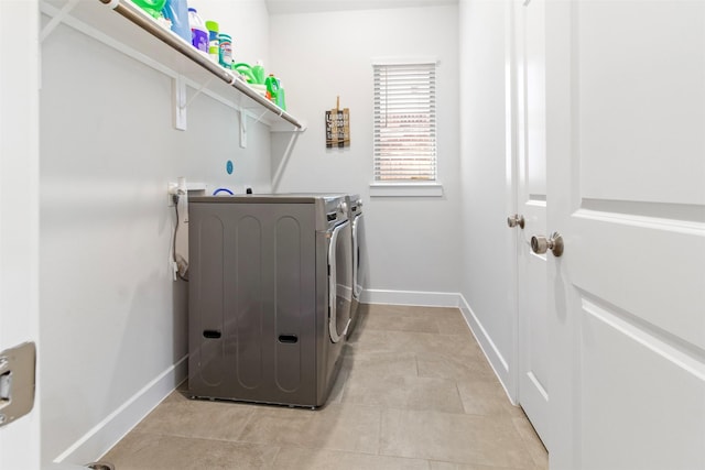 clothes washing area featuring washer and clothes dryer