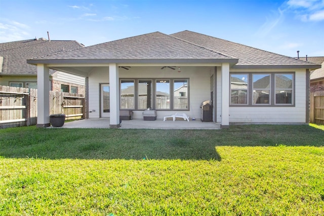 back of property featuring a lawn, ceiling fan, and a patio