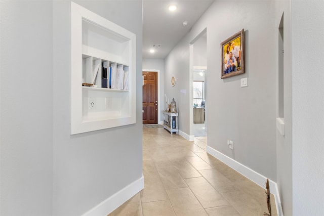 hall featuring light tile patterned floors