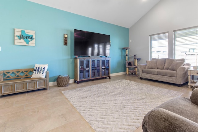 living room featuring high vaulted ceiling and light tile patterned flooring