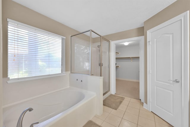 bathroom with separate shower and tub and tile patterned floors