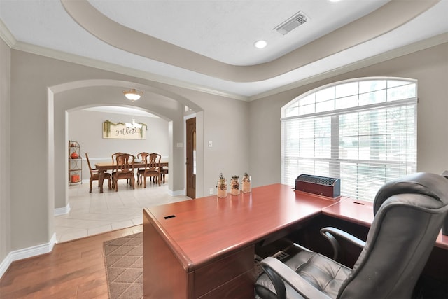 office featuring hardwood / wood-style flooring, a tray ceiling, and crown molding