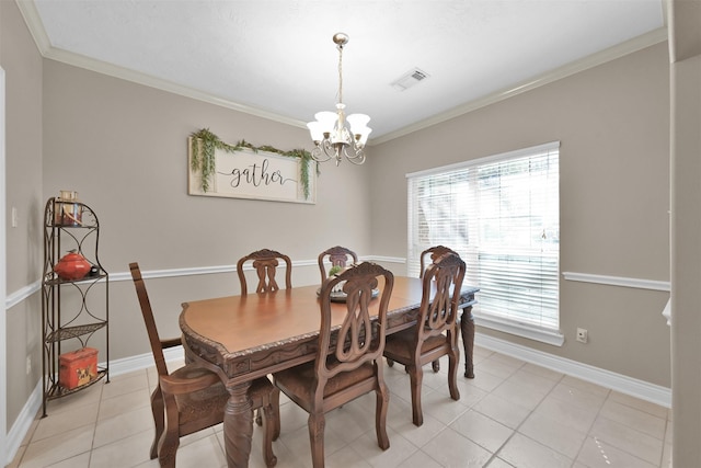 dining room with an inviting chandelier, ornamental molding, and light tile patterned floors