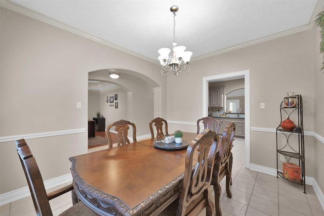 dining area with an inviting chandelier, ornamental molding, light tile patterned floors, and sink