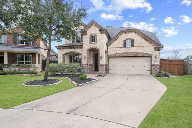 french provincial home with a garage and a front lawn