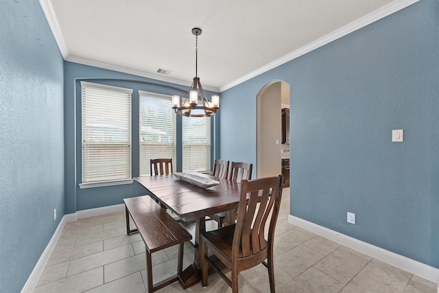 tiled dining space with crown molding and a chandelier