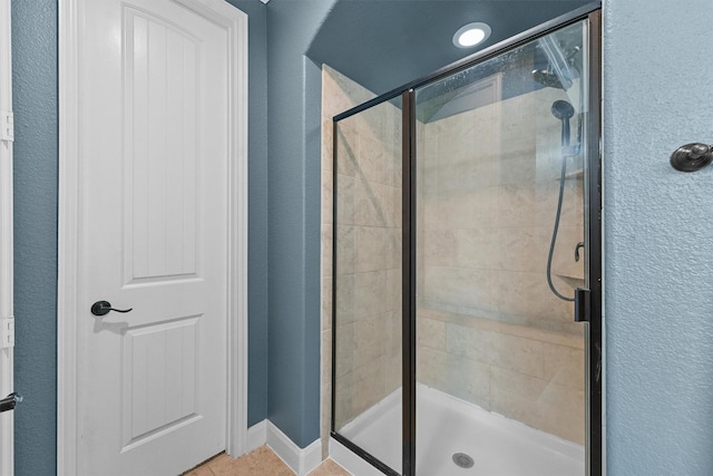 bathroom with tile patterned flooring and an enclosed shower