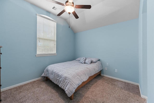 bedroom featuring ceiling fan, vaulted ceiling, and carpet