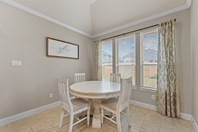 tiled dining room with ornamental molding and lofted ceiling