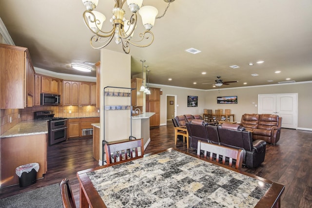 dining room featuring ceiling fan with notable chandelier, ornamental molding, and dark hardwood / wood-style floors