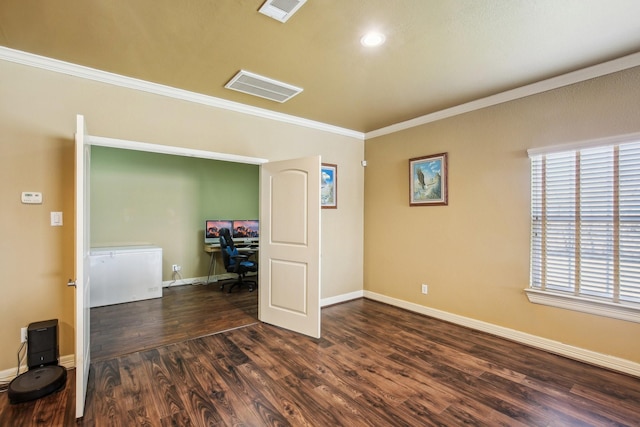 empty room with ornamental molding and dark hardwood / wood-style flooring