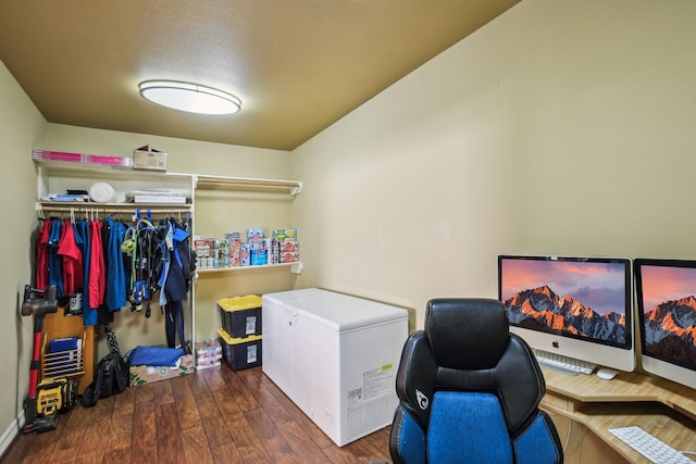 clothes washing area featuring a textured ceiling and dark hardwood / wood-style flooring