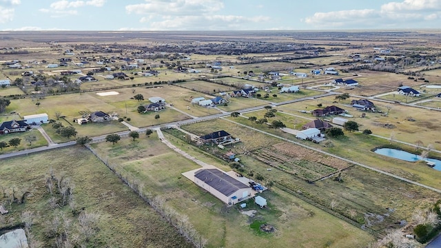 aerial view with a water view and a rural view