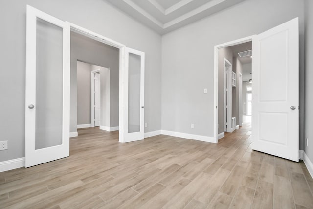 unfurnished bedroom featuring french doors and light wood-type flooring