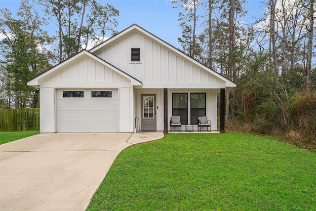 modern inspired farmhouse featuring a front yard, a garage, and a porch