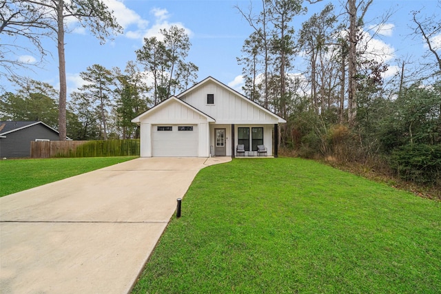 view of front of house with a porch, a front lawn, and a garage