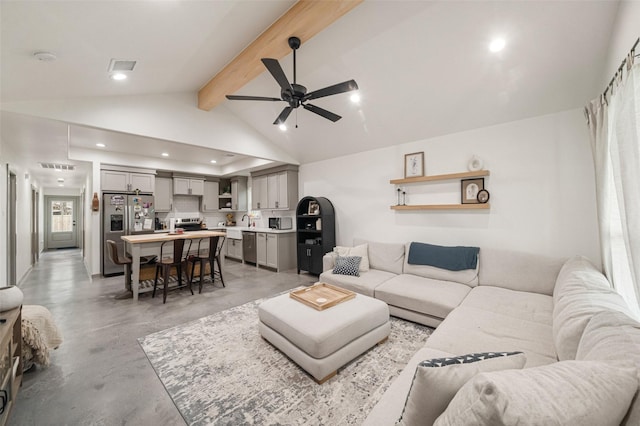 living room with sink, concrete flooring, ceiling fan, and vaulted ceiling with beams