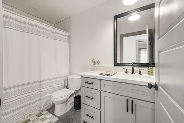 bathroom featuring toilet, vanity, and walk in shower