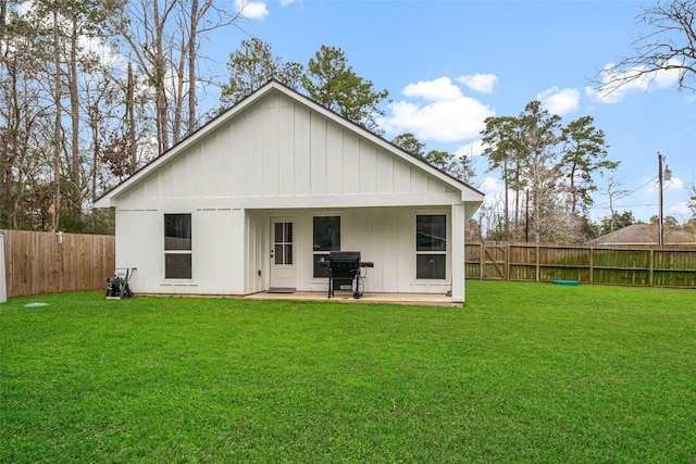 back of property featuring a lawn and a patio area