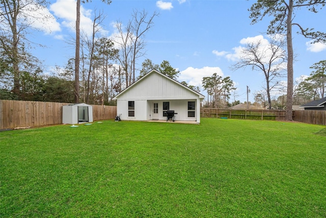 back of property featuring a yard and a storage shed