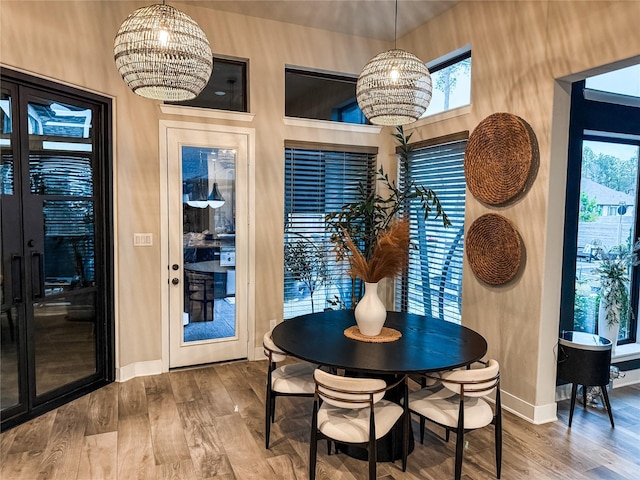 dining space featuring an inviting chandelier and hardwood / wood-style flooring