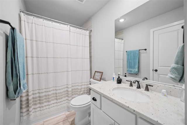 full bathroom featuring toilet, vanity, tile patterned flooring, and shower / bath combo with shower curtain