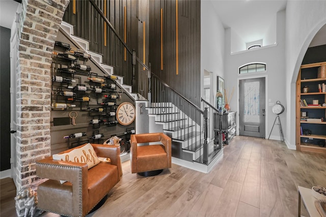 foyer entrance with a high ceiling and hardwood / wood-style floors