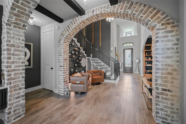 foyer entrance with beam ceiling and hardwood / wood-style flooring