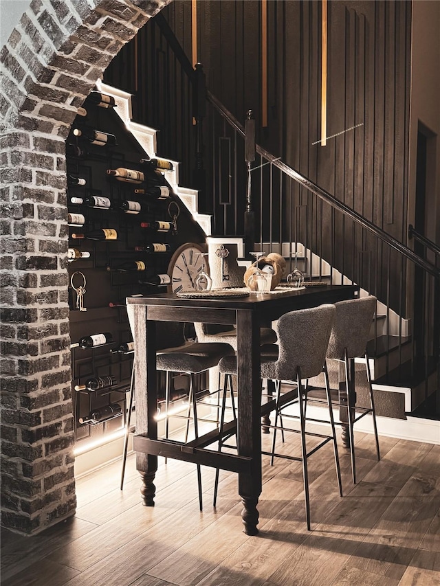 wine room with wooden walls and hardwood / wood-style floors