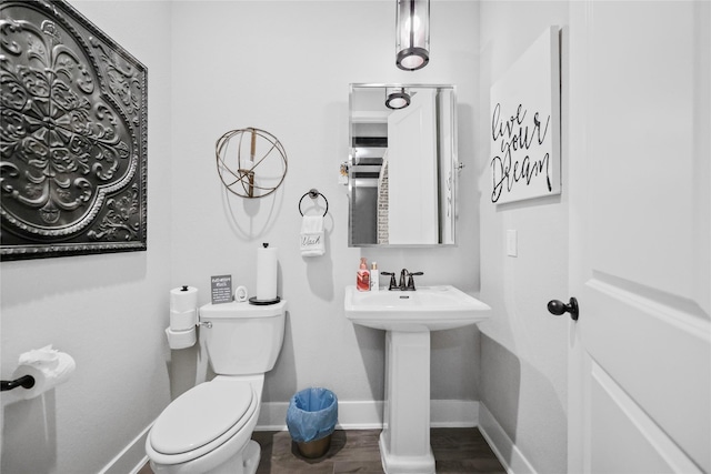 bathroom with sink, hardwood / wood-style floors, and toilet