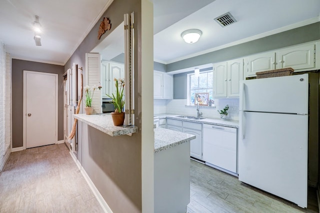 kitchen with white appliances, light wood-type flooring, backsplash, white cabinetry, and sink