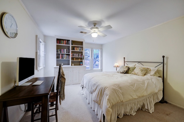 carpeted bedroom with ceiling fan and crown molding