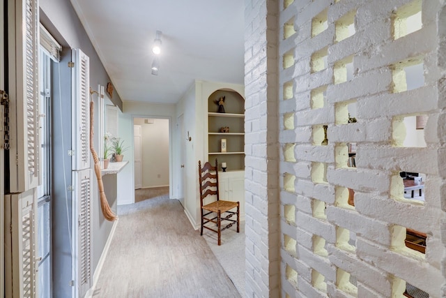 hallway featuring built in features and light hardwood / wood-style flooring