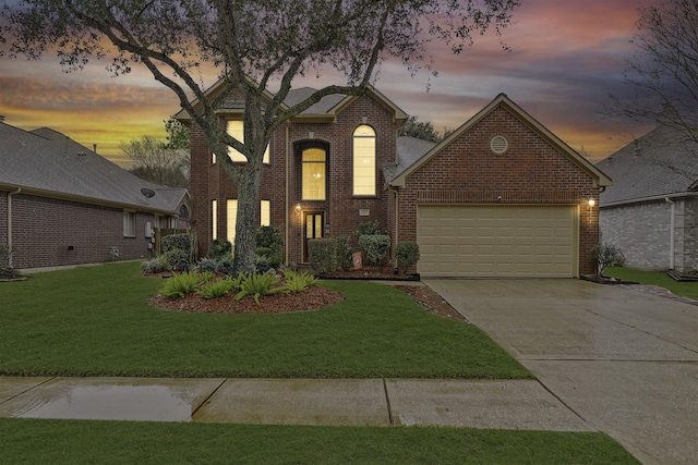 view of front of property with a garage and a lawn