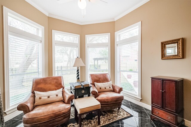 living area featuring ornamental molding and ceiling fan