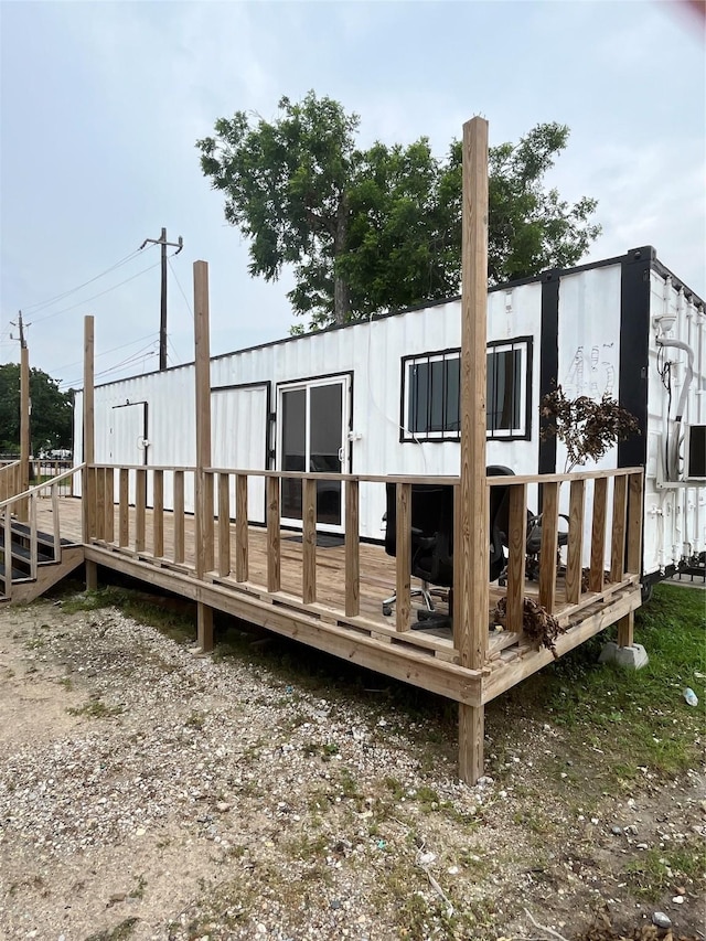 rear view of property featuring a deck