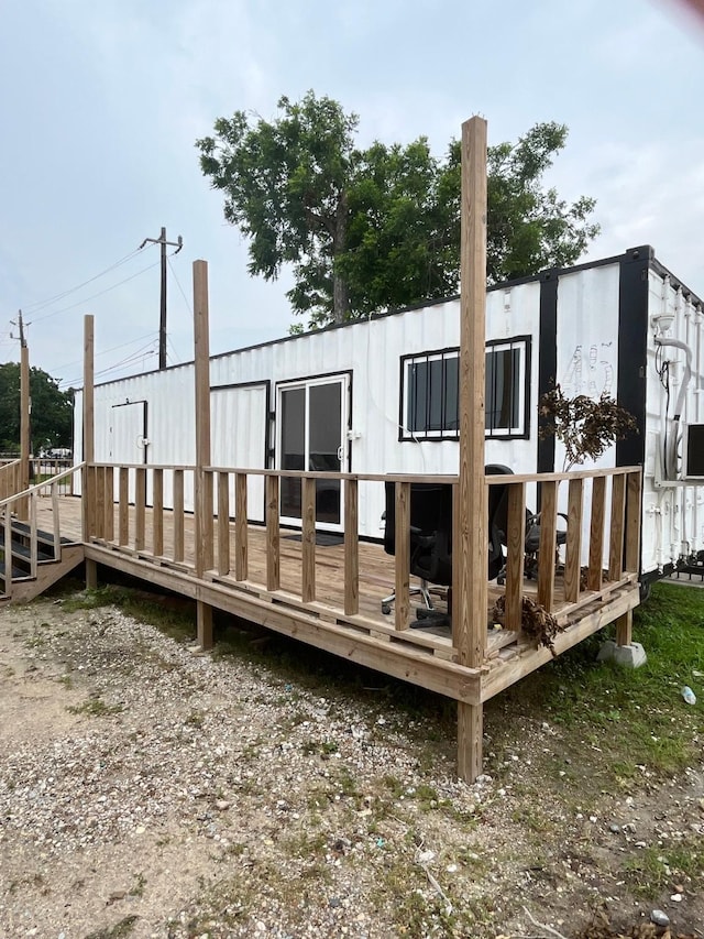 rear view of house featuring a deck