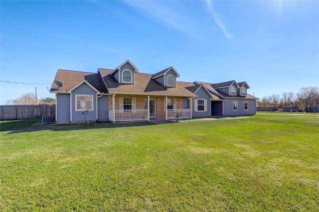 cape cod house with a porch, central air condition unit, and a front lawn