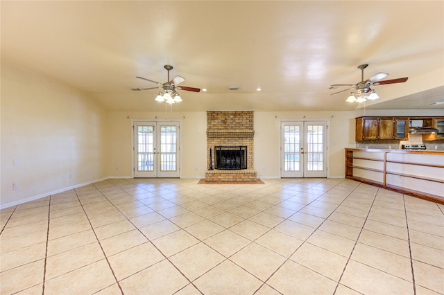 unfurnished living room with french doors, plenty of natural light, and light tile patterned floors