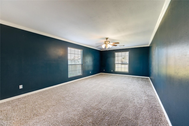 carpeted empty room with ceiling fan and crown molding