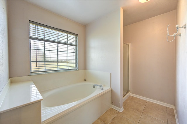 bathroom with tile patterned floors and plus walk in shower